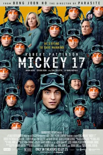 Mickey 17 (2025) - Movie Poster. The movie poster features a group of individuals dressed in green military-style uniforms, with goggles covering their eyes, creating a uniform appearance. The background is a gradient of yellow and orange hues. At the top, the text reads, "FROM BONG JOON HO THE DIRECTOR OF PARASITE." Below this, the title "MICKEY 17" is prominently displayed in large, bold letters. The names "ROBERT PATTINSON," "NAOMI ACKIE," "STEVEN YEUN," "TONI COLLETTE," and "MARK RUFFALO" are listed below the title. The tagline "HE'S DYING TO SAVE MANKIND" is situated above the title. At the bottom, the text indicates that the movie is produced by Warner Bros. Pictures and is set to be released in theaters on March 7, 2025. The poster also includes the logos of various production companies and the IMAX logo, suggesting that the movie will be available in IMAX format.