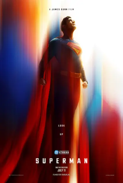 Superman (2025) - Movie Poster. The movie poster features a superhero standing tall, gazing upwards with a determined expression. The background is a vibrant blend of red, blue, and orange hues, creating a dynamic and energetic atmosphere. The superhero is wearing a classic costume with a prominent red and yellow "S" emblem on the chest. The text on the poster reads "A JAMES GUNN FILM" at the top, followed by "LOOK UP" in the middle. Below that, the title "SUPERMAN" is prominently displayed in bold, white letters. Additional details include "ONLY IN THEATERS JULY 11" and "FILMED FOR IMAX" at the bottom. The overall design conveys a sense of heroism and adventure.