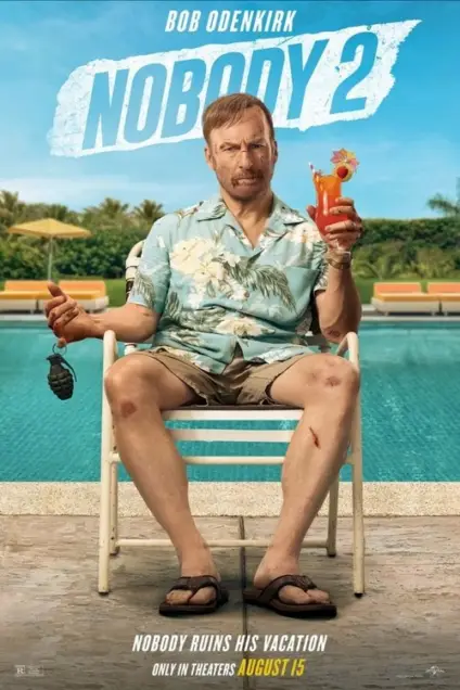 Nobody 2 (2025) - Movie Poster. The movie poster features a man sitting by a pool, holding a tropical drink with a straw and a small umbrella. He is wearing a light blue, floral-patterned shirt and shorts, along with flip-flops. In his left hand, he holds a grenade. The background includes a clear blue sky, palm trees, and a few lounge chairs. The title "NOBODY 2" is prominently displayed at the top in large, bold letters. At the bottom, the text reads, "NOBODY RUINS HIS VACATION ONLY IN THEATERS AUGUST 15."