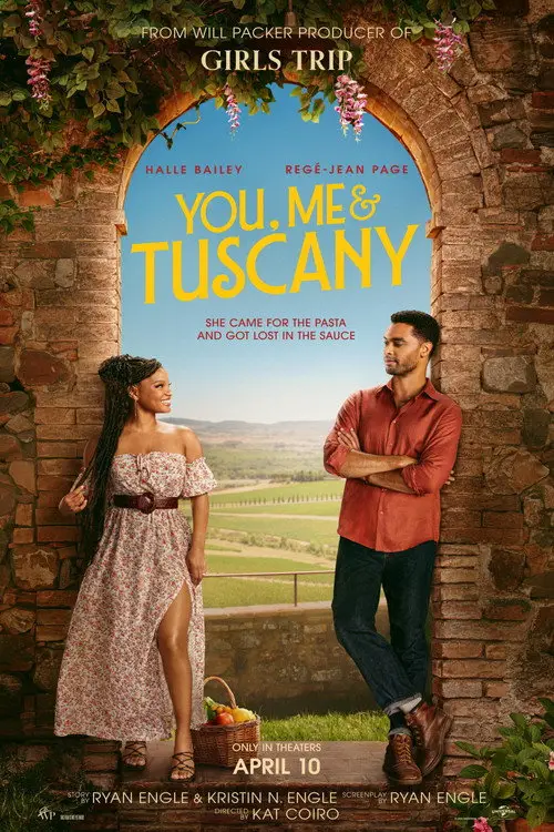 You, Me & Tuscany (2026) - Movie Poster. The movie poster features a rustic stone archway with lush greenery and pink flowers hanging from the top. Inside the archway, there is a scenic view of a picturesque landscape with rolling hills and a clear blue sky. Two characters are prominently displayed: a woman on the left wearing a floral off-shoulder dress and a man on the right in a red shirt and jeans. The woman is holding a basket filled with fresh produce, suggesting a connection to nature or a rural setting. The title "YOU, ME & TUSCANY" is displayed in large, bold letters at the top of the archway. Below the title, there is a tagline that reads, "She came for the pasta and got lost in the sauce." The poster also includes the release date, "APRIL 10," and credits for the producers, writers, and director. The overall aesthetic of the poster conveys a romantic and adventurous theme set in Tuscany.