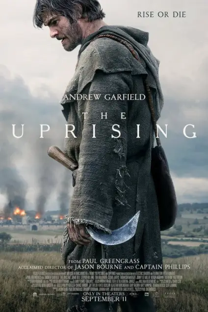 The Uprising (2026) - Movie Poster. The movie poster features a man standing in a field, facing away from the viewer. He is wearing a tattered, hooded cloak and holding a large, curved blade, possibly a sword or a scythe. The background shows a dramatic landscape with smoke rising from a distant fire, suggesting a chaotic or war-torn setting. The title "The Uprising" is prominently displayed in bold, white letters across the middle of the poster. Above the title, the text "Rise or Die" is written in smaller, uppercase letters. The bottom of the poster includes additional information: "From Paul Greengrass, acclaimed director of Jason Bourne and Captain Phillips," and "Only in theaters September 11." The overall tone of the poster is intense and dramatic, hinting at a story of struggle and conflict.