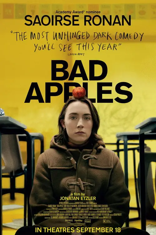 Bad Apples (2026) - Movie Poster. The movie poster features a young woman with long brown hair, wearing a brown coat, standing in a classroom setting. She has an apple on her head, which is a central visual element. The background is a gradient of yellow and orange, giving a warm and somewhat eerie atmosphere. At the top of the poster, there is text that reads "Academy Award® nominee SAOIRSE RONAN" and below it, "THE MOST UNHINGED DARK COMEDY YOU'LL SEE THIS YEAR." The title "BAD APPLES" is prominently displayed in large, bold letters. At the bottom, it states "a film by JONATAN ETZLER" and "IN THEATRES SEPTEMBER 18." The overall design suggests a dark comedy with a twist, likely involving the young woman and the apple.
